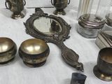 a table with a lot of silver objects on it