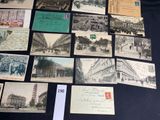 several old postcards and postcards are on display on a table