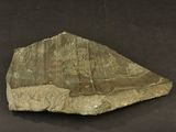 a large rock with writing on it on a black surface