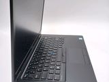 a black laptop with a blue keyboard on a white surface