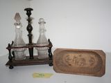 three glass vases sitting on a table next to a wooden plaque