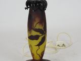 a brown and yellow vase with a dragon on it