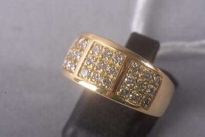 yellow gold ring with diamonds on top of a black piece of leather