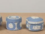 three blue and white vases sitting on a table