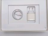 a white box with a charger and a cable in it