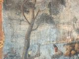 a painting on the wall of a building that has a painting of a boat in the water