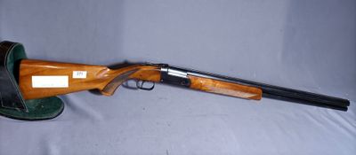 a shotgun that is laying on a table with a hat on it