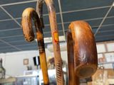 a person holding a pair of walking canes in a store