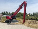 a red crane that is standing in the dirt