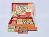a wooden box filled with assorted books and cards
