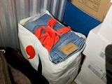 a pile of clothes sitting on top of a cardboard box