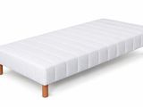 white leather bench with wooden legs on a white background