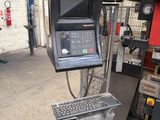 an image of a computer and keyboard on a stand