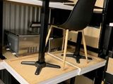 a table and chairs in a room with a lot of boxes on the floor