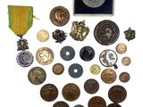 a lot of coins and medals on a white surface