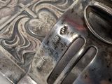 a silver plate with a spoon on it on a table
