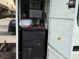 an image of a truck with a refrigerator in the back