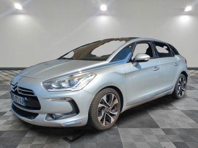 a silver car is parked on a checkered floor in a room