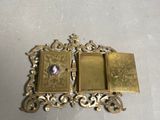 a gold picture frame with a picture of a woman on it