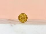 a gold coin sitting on top of a marble counter top