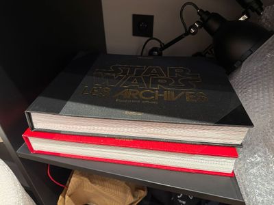 a stack of books sitting on top of a book shelf