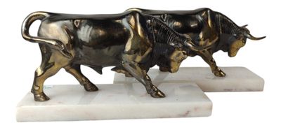 statue of a bull on a marble base on a white background