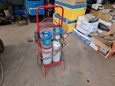 a cart with two gas cylinders on it in a garage