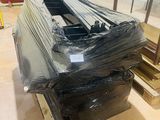 a large pile of black plastic material on a pallet