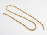 a gold chain necklace on a white background