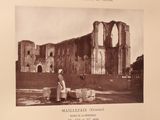 an old photo of a woman standing in front of a building