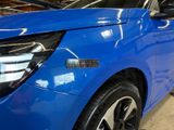 a blue car that is parked in a garage