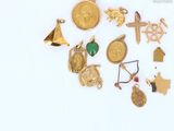 many different types of gold jewelry on a white surface