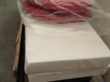 a mattress that is sitting on a cart in a room