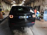 a black car that is parked in a garage