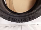 tire of a car on a white surface with a cardboard box in the background
