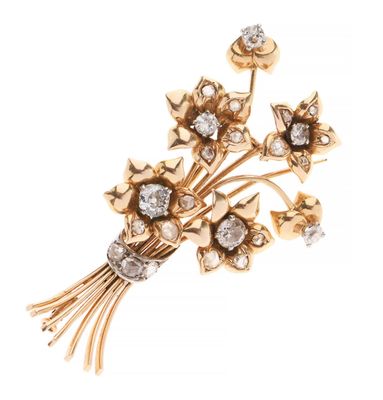 un gros plan d'une broche ornée de fleurs et de diamants