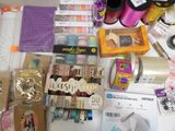 a table that has many items on it including scissors, tape, tape cutters, and other items