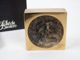 golden box with a black and white stone in it and a black box with a black and white stone in it