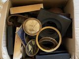 a box full of assorted items sitting on a bed