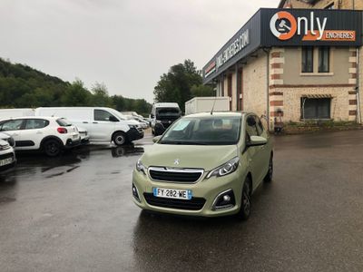 a green car parked in front of a building with a sign on it