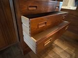 two drawers that are open on the side of a dresser