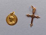 deux croix en or et une médaille en or sur un fond blanc