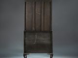 an old wooden cabinet with a drawer on wheels on a grey background