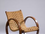 une image représentant un fauteuil à bascule en bois avec une assise tressée