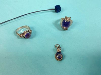 a close up of three different pieces of jewelry on a table
