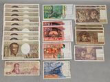 several different bank notes are laid out on a table