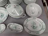 a lot of plates and bowls on the table