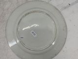 a white plate with a sticker on it sitting on a table