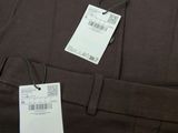 a close up of a brown shirt with a tag on it