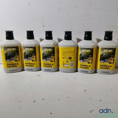 four bottles of liquid sitting on a table next to each other
